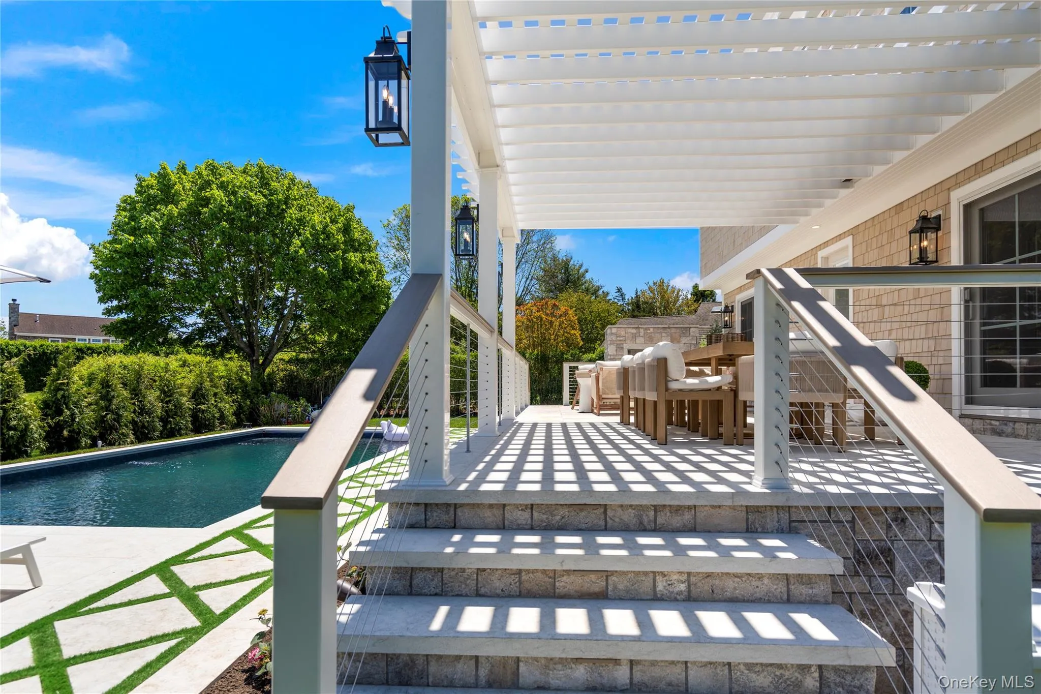 Swimming pool featuring a patio and outdoor dining space Swimming pool featuring a patio and outdoor dining space