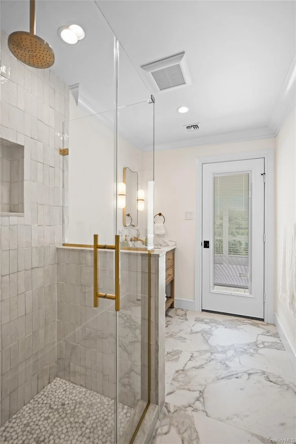 Bathroom with a stall shower, vanity, light marble finish floors, recessed lighting, and crown molding Bathroom with a stall shower, vanity, light marble finish floors, recessed lighting, and crown molding