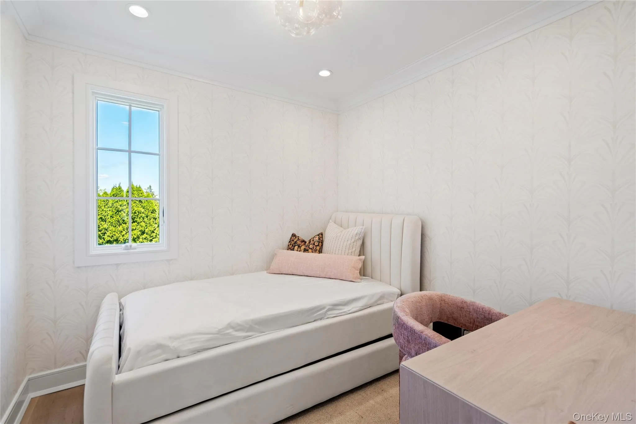 Bedroom with wallpapered walls and ornamental molding Bedroom with wallpapered walls and ornamental molding