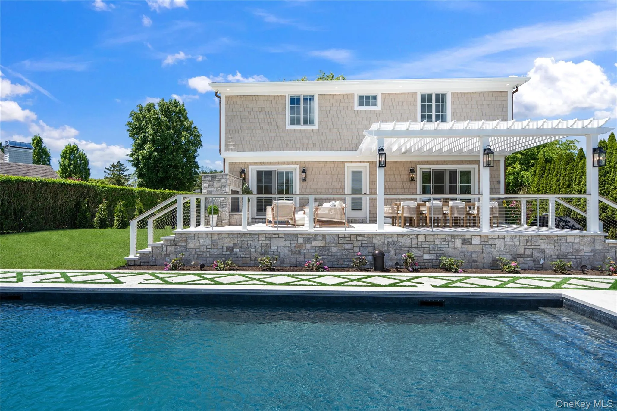 Rear view of house with a patio, an outdoor pool, a pergola, and an outdoor hangout area Rear view of house with a patio, an outdoor pool, a pergola, and an outdoor hangout area