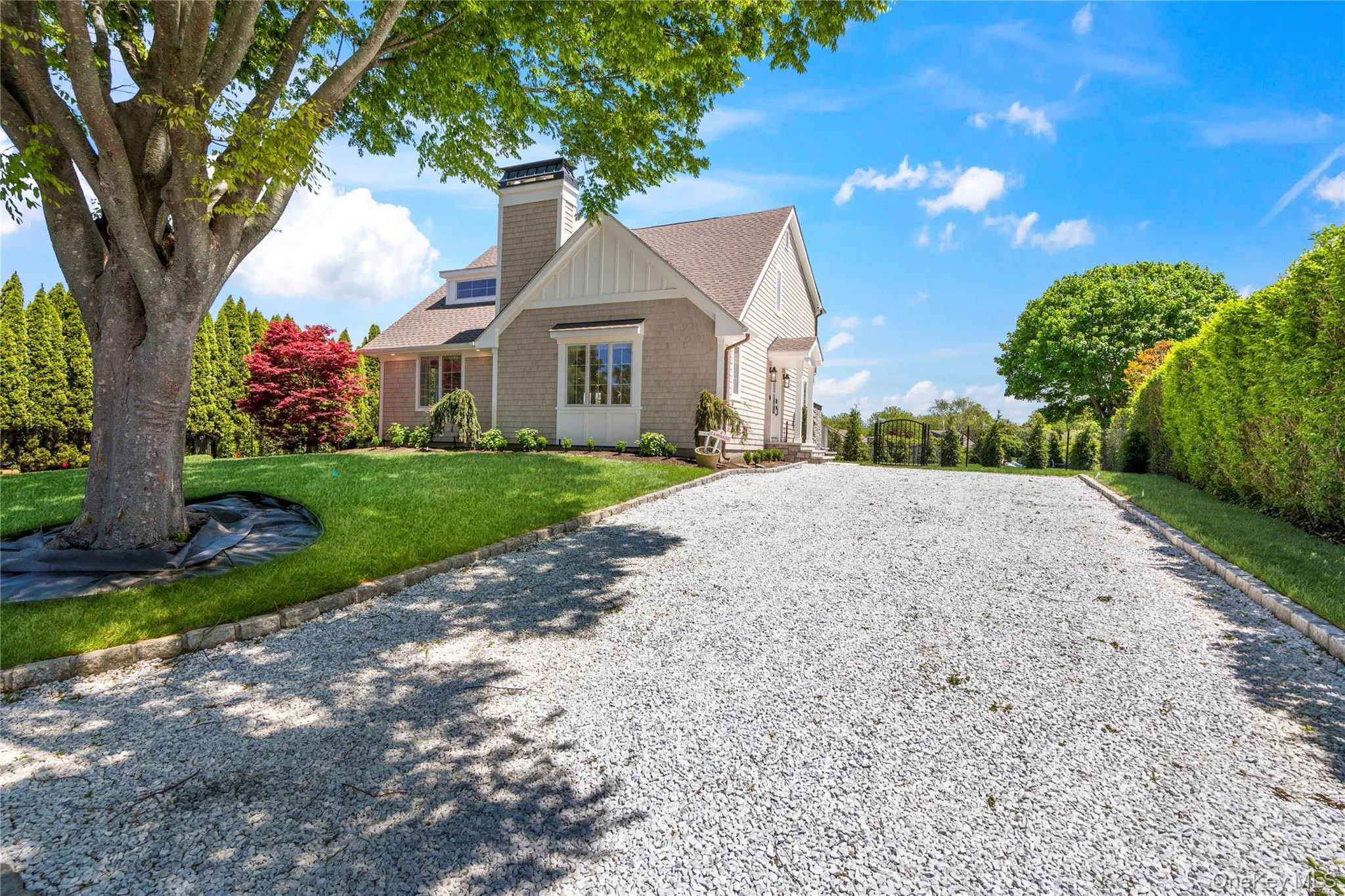 View of front of property featuring a front lawn, driveway, roof with shingles, and a chimney View of front of property featuring a front lawn, driveway, roof with shingles, and a chimney