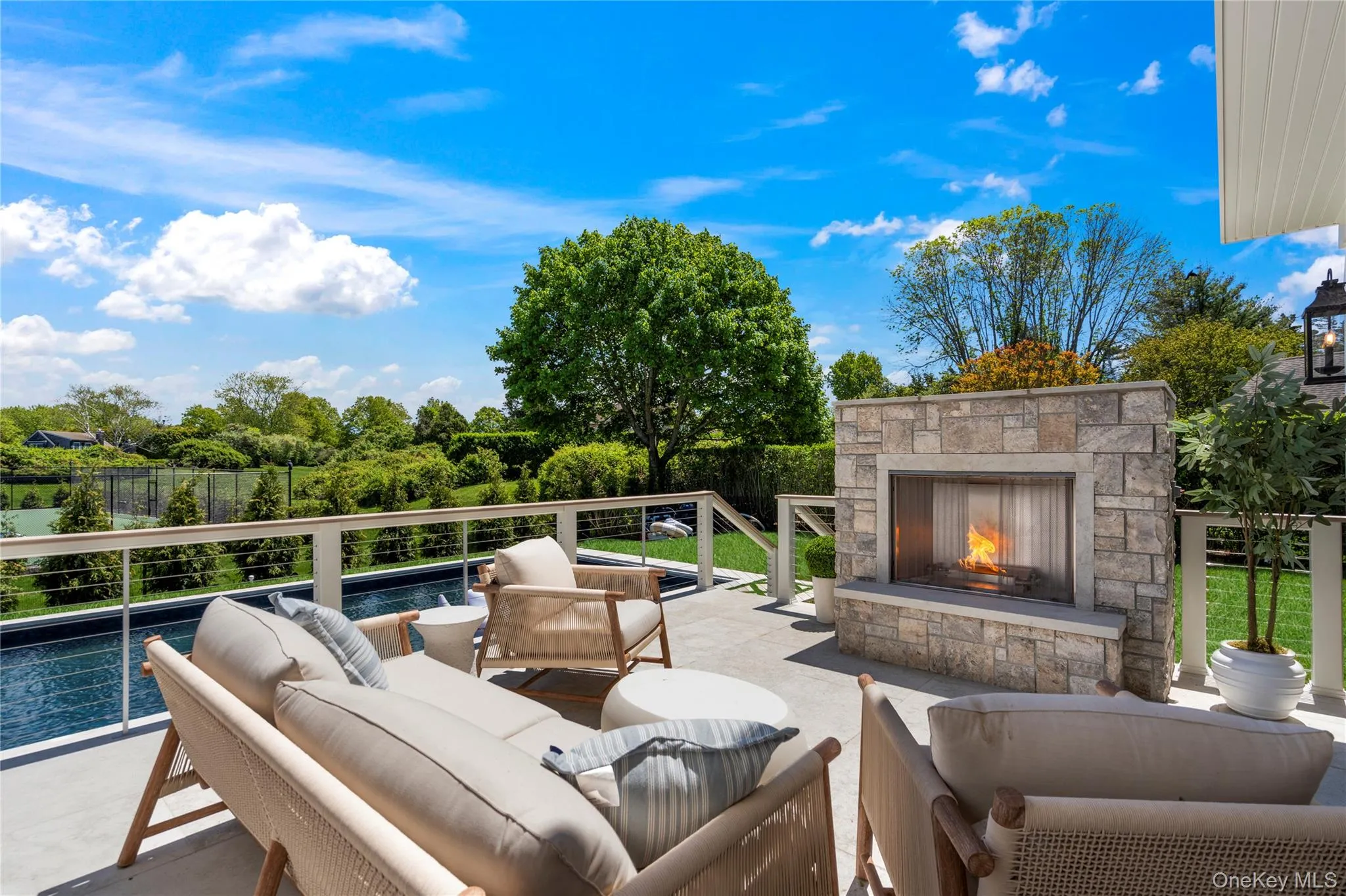 View of patio / terrace with an outdoor living space with a fireplace View of patio / terrace with an outdoor living space with a fireplace