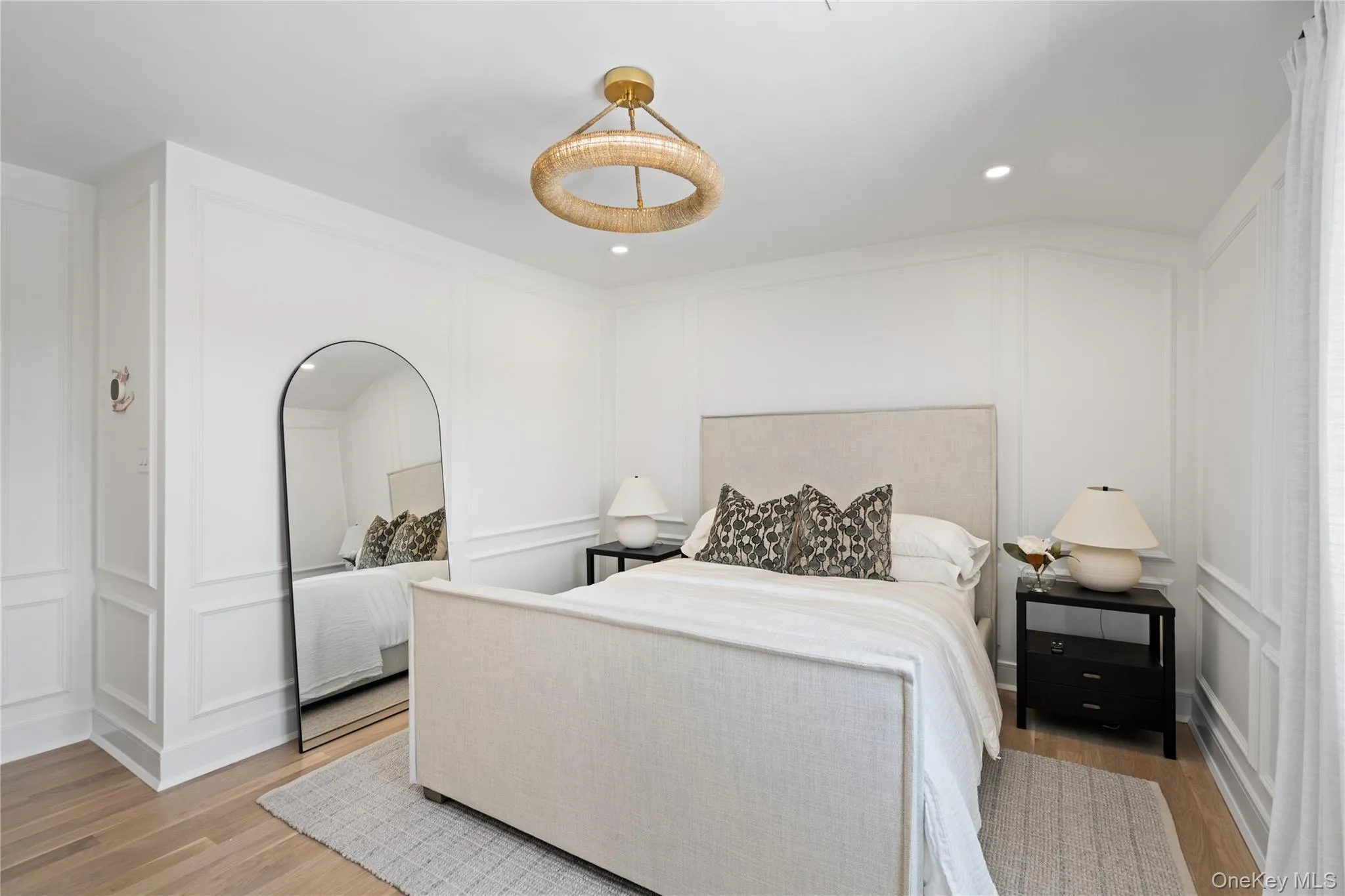 Bedroom featuring a decorative wall, light wood-style flooring, and recessed lighting Bedroom featuring a decorative wall, light wood-style flooring, and recessed lighting