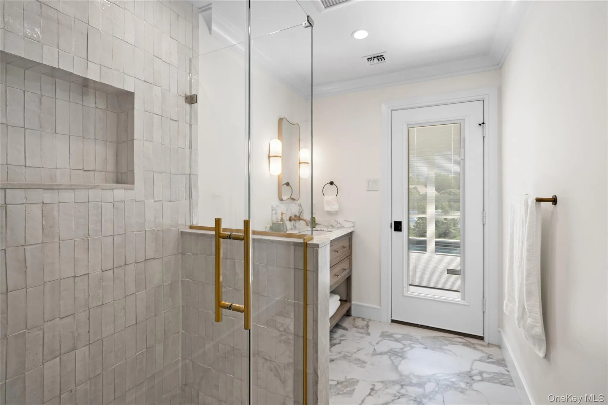 Full bathroom with light marble finish flooring, vanity, a shower stall, ornamental molding, and recessed lighting Full bathroom with light marble finish flooring, vanity, a shower stall, ornamental molding, and recessed lighting