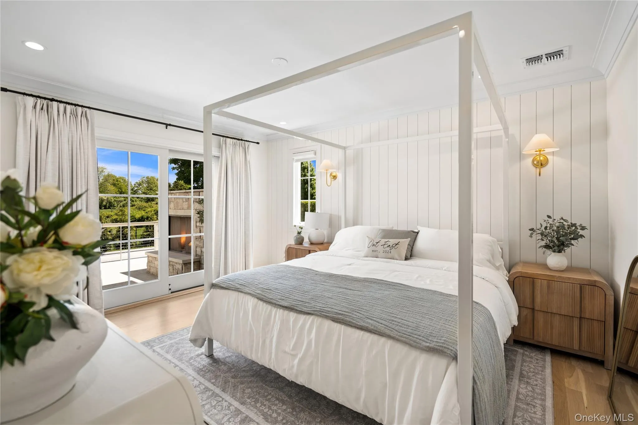 Bedroom with access to outside, wood finished floors, and ornamental molding Bedroom with access to outside, wood finished floors, and ornamental molding