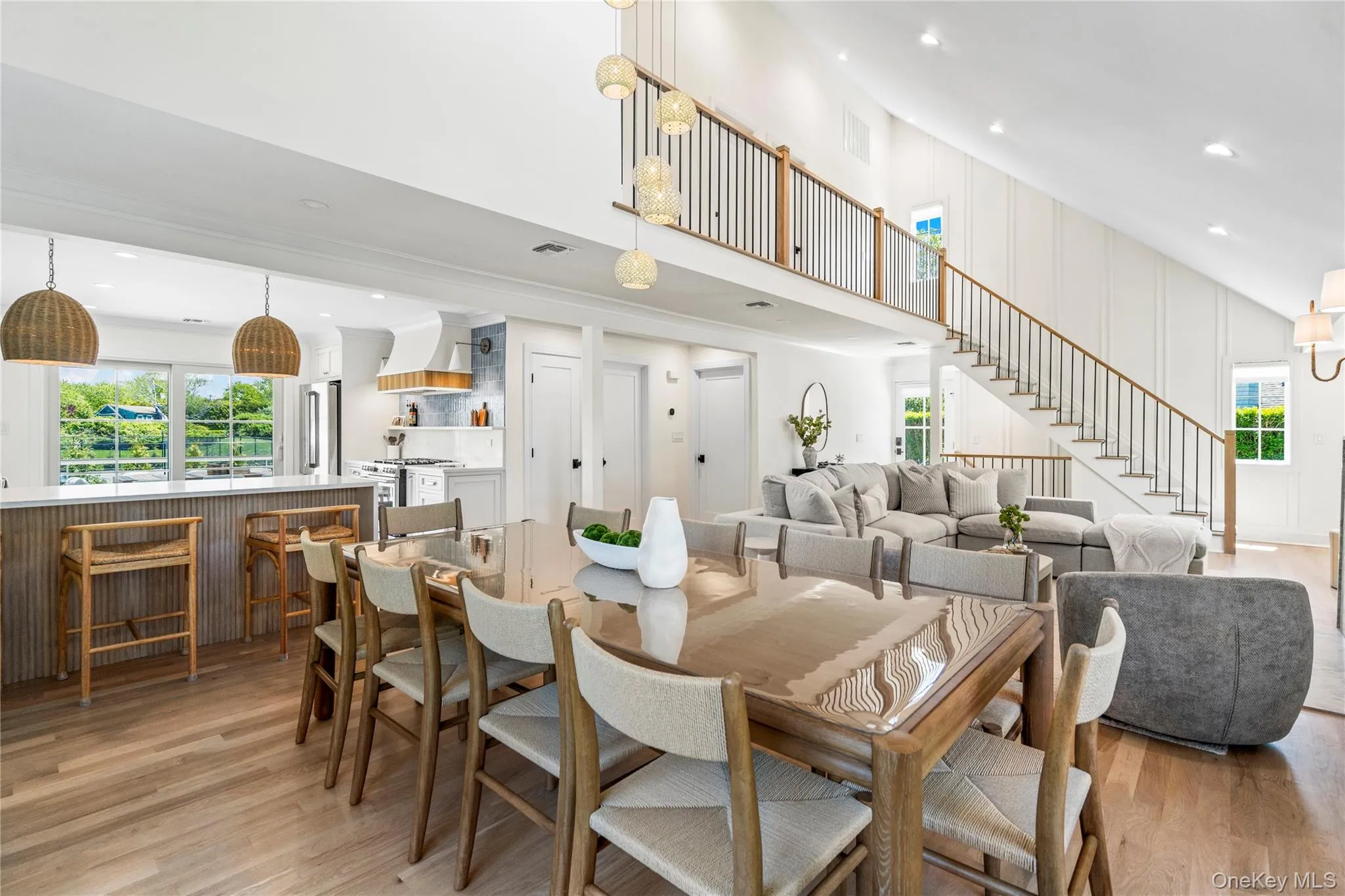 Dining room with recessed lighting, light wood-style floors, and a towering ceiling Dining room with recessed lighting, light wood-style floors, and a towering ceiling