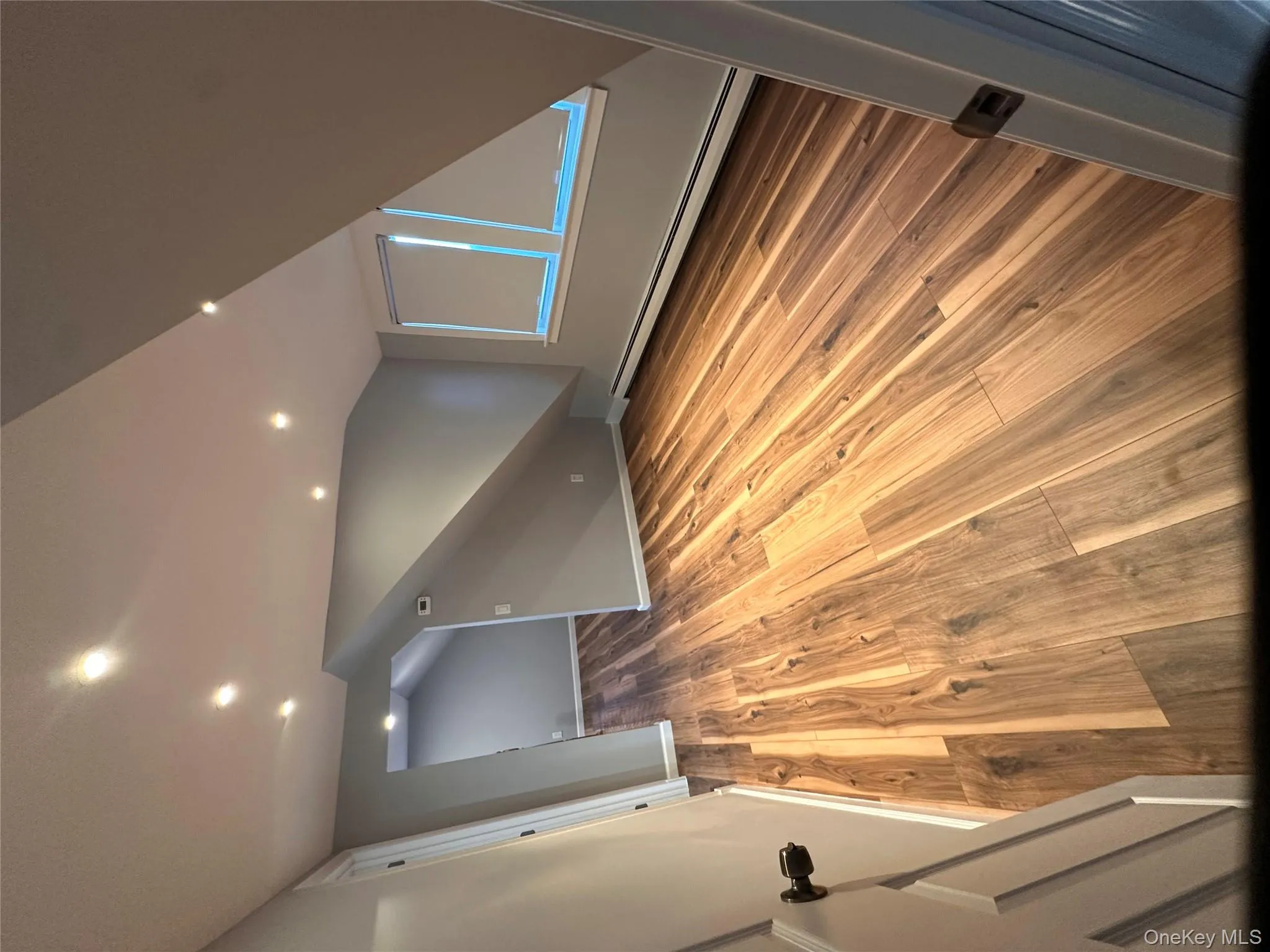 Bonus room with a baseboard radiator, light wood-style flooring, recessed lighting, and lofted ceiling Bonus room with a baseboard radiator, light wood-style flooring, recessed lighting, and lofted ceiling