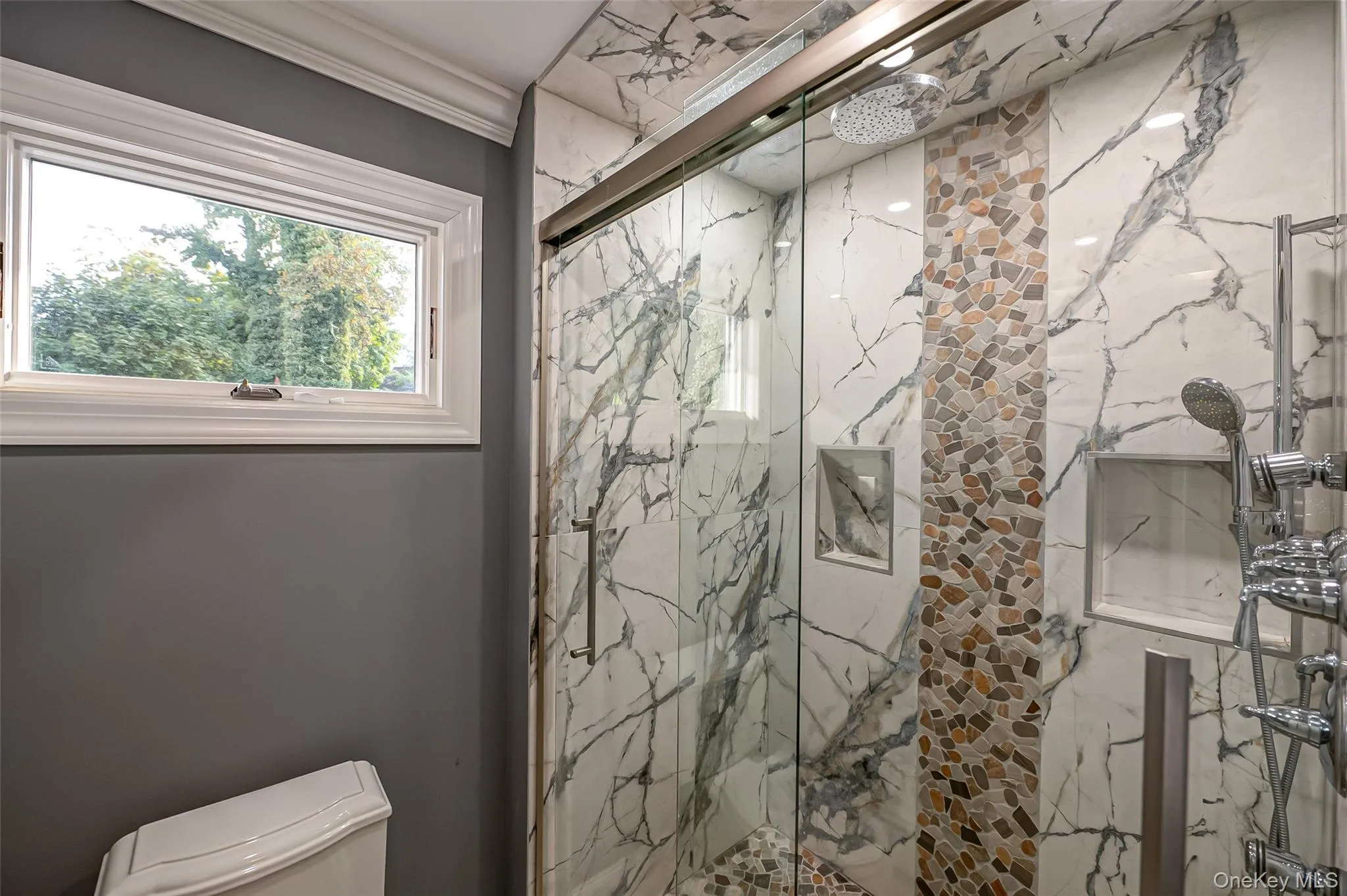 Primary Ensuite Full bath featuring a walk-in shower and window. Primary Ensuite Full bath featuring a walk-in shower and window.