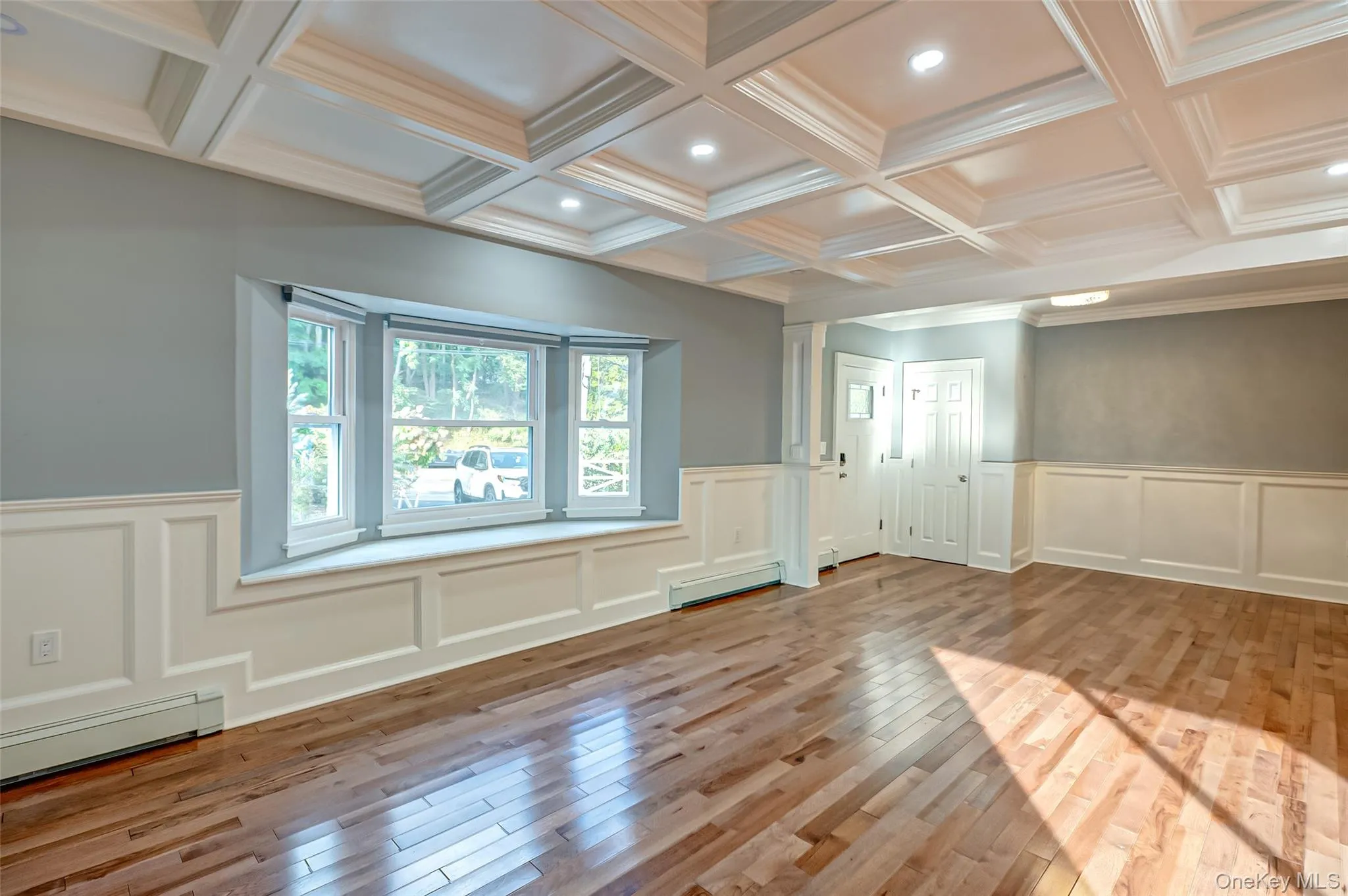 Bright living room with picture window, wood floors. Bright living room with picture window, wood floors.