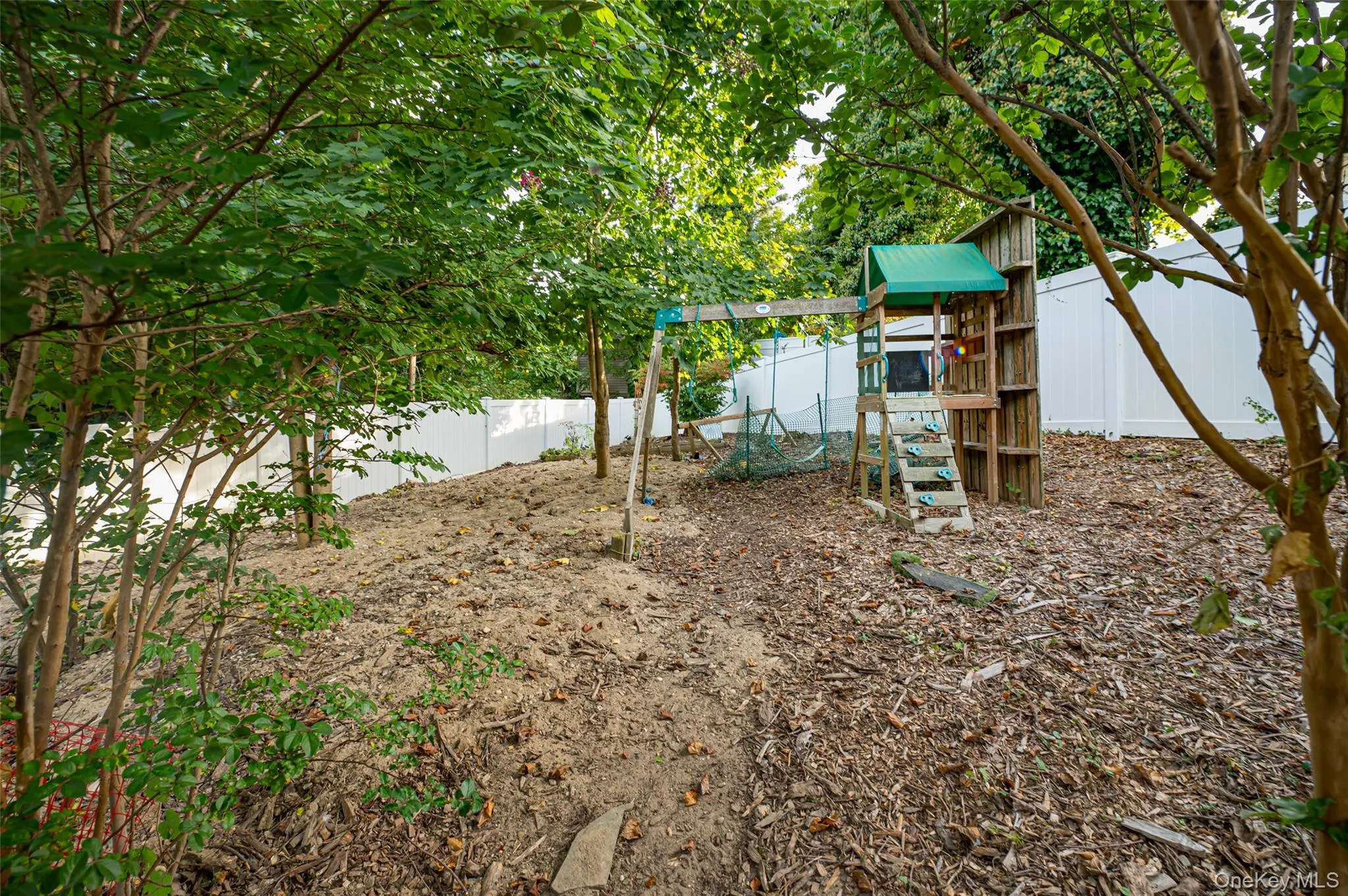 Fenced backyard featuring a play set. Fenced backyard featuring a play set.