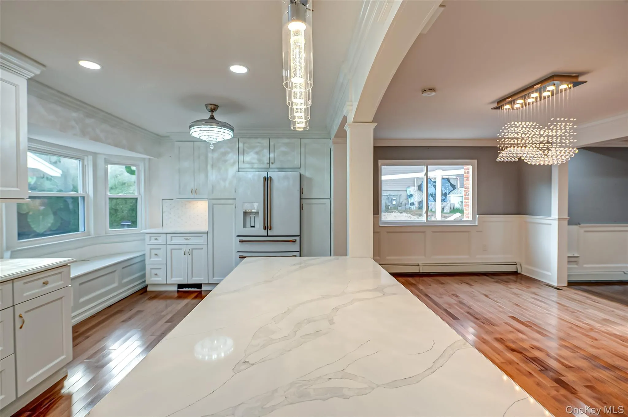 Kitchen featuring marble counter tops and island. Kitchen featuring marble counter tops and island.