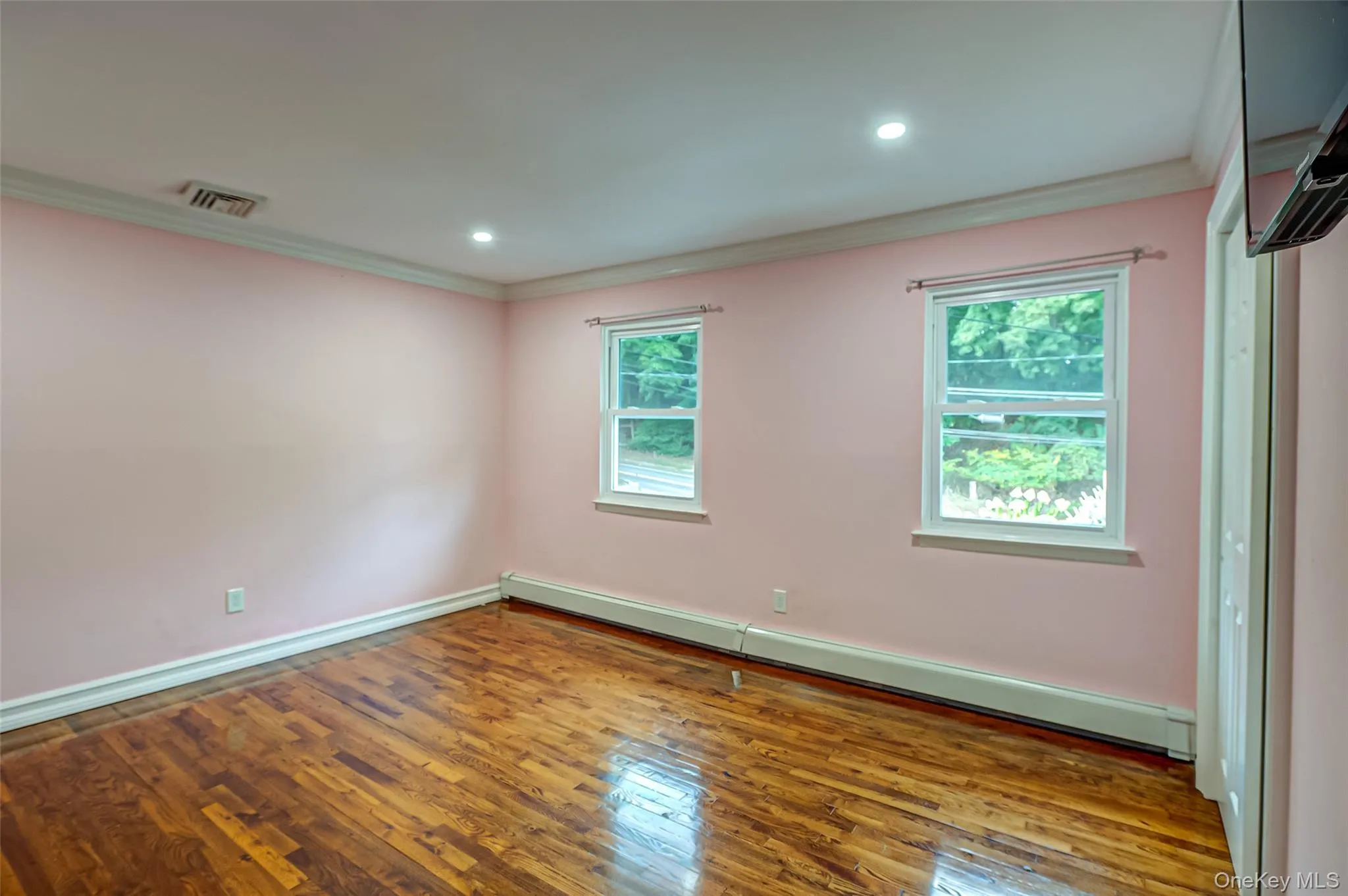3rd bedroom with wood flooring, large closet, ornamental molding, and recessed lighting 3rd bedroom with wood flooring, large closet, ornamental molding, and recessed lighting