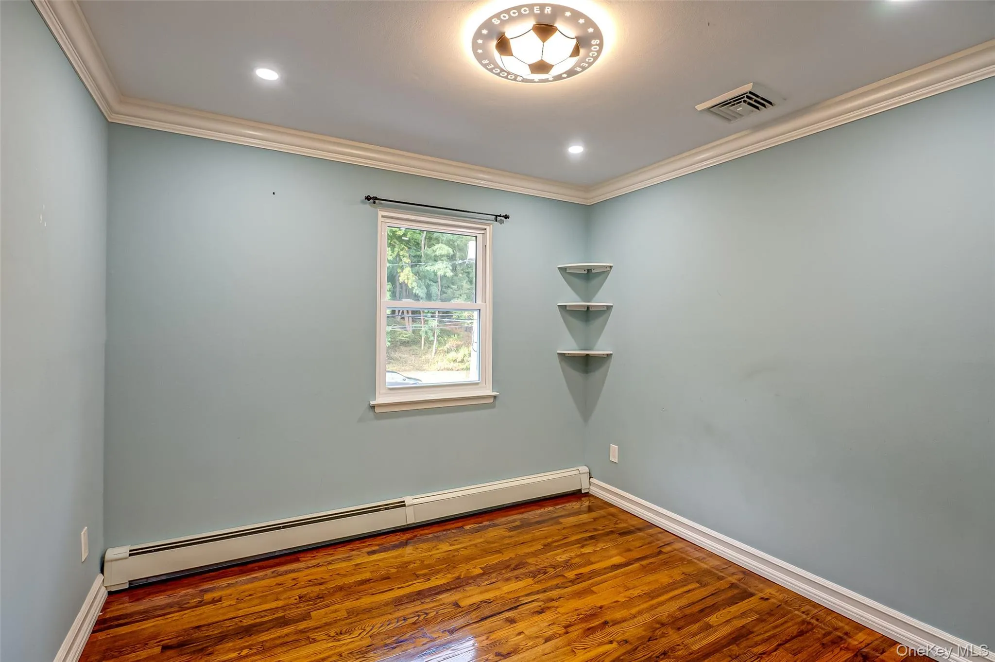 2nd bedroom with wood finished floors, ornamental molding, and recessed lighting 2nd bedroom with wood finished floors, ornamental molding, and recessed lighting