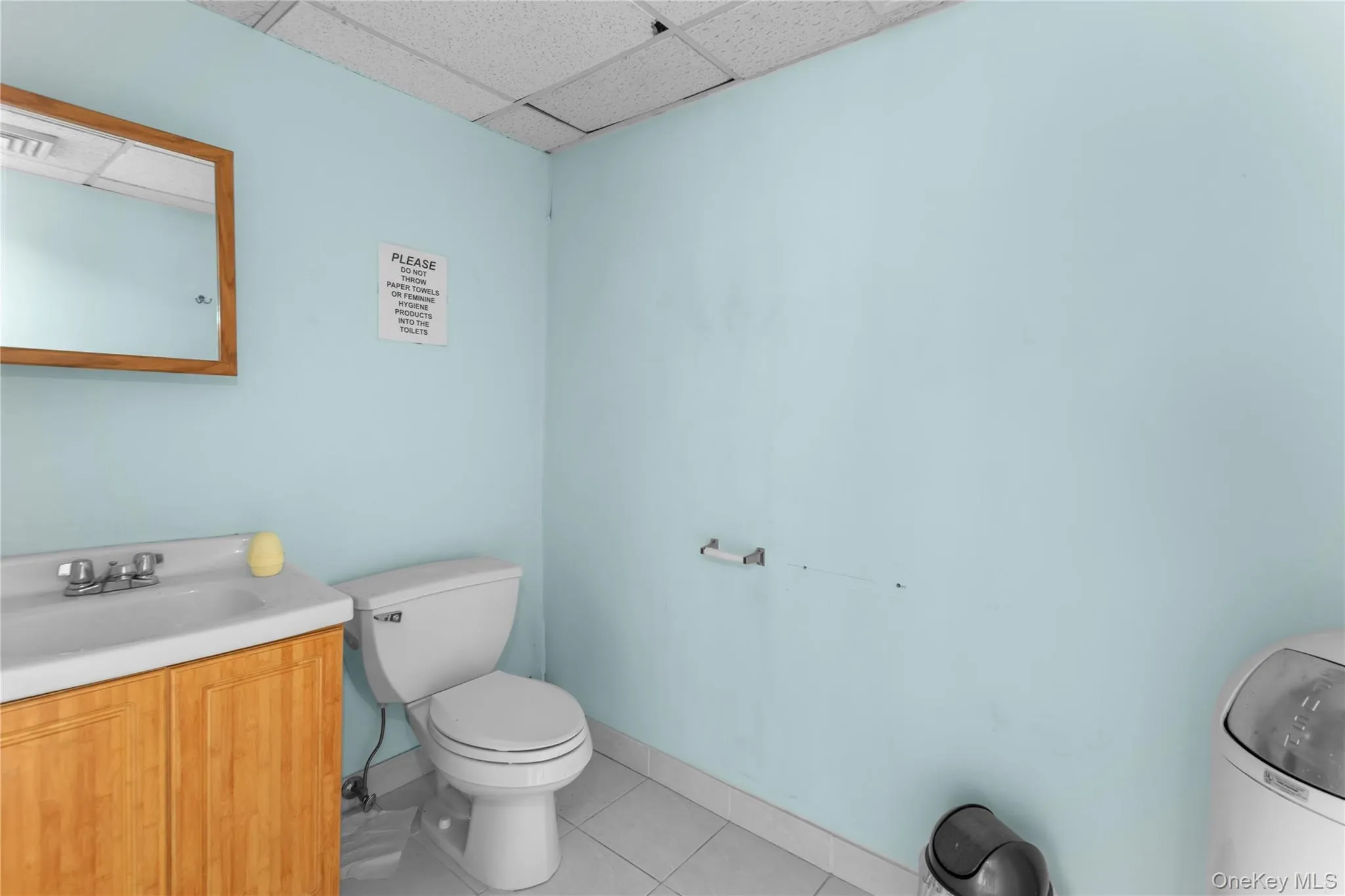 Bathroom with a drop ceiling and vanity Bathroom with a drop ceiling and vanity