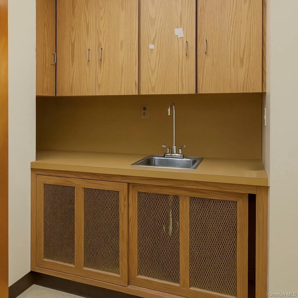 Bar featuring a sink and light countertops Bar featuring a sink and light countertops