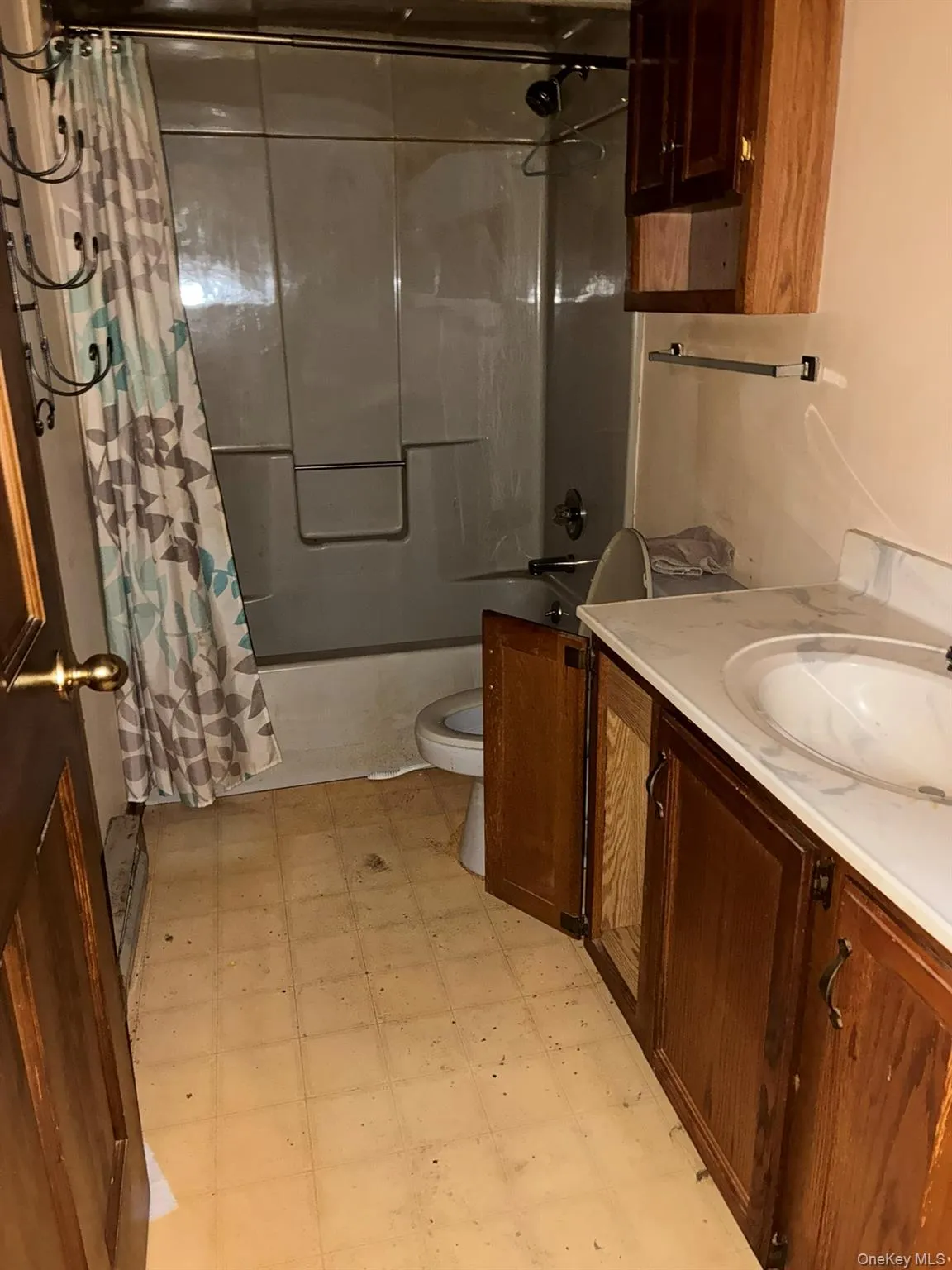 Main Full bathroom featuring light floors, shower / bathtub combination with curtain, and vanity Main Full bathroom featuring light floors, shower / bathtub combination with curtain, and vanity
