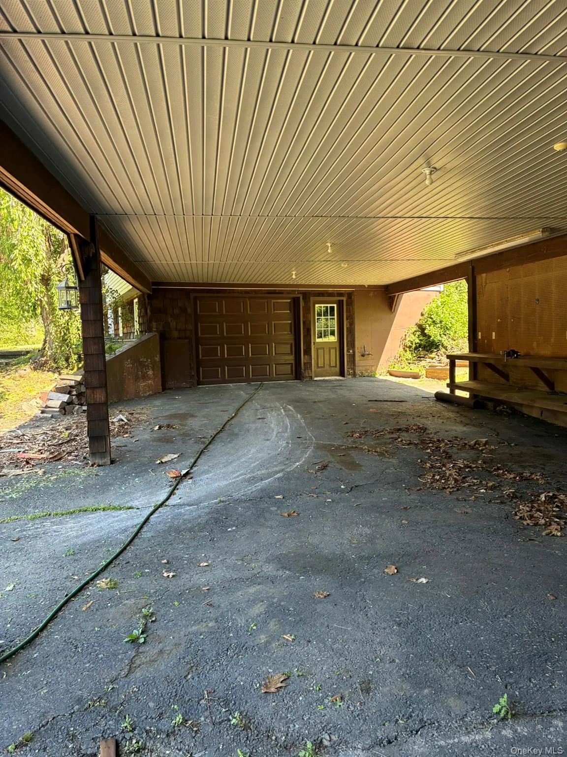 View of patio / terrace featuring a carport and a garage View of patio / terrace featuring a carport and a garage