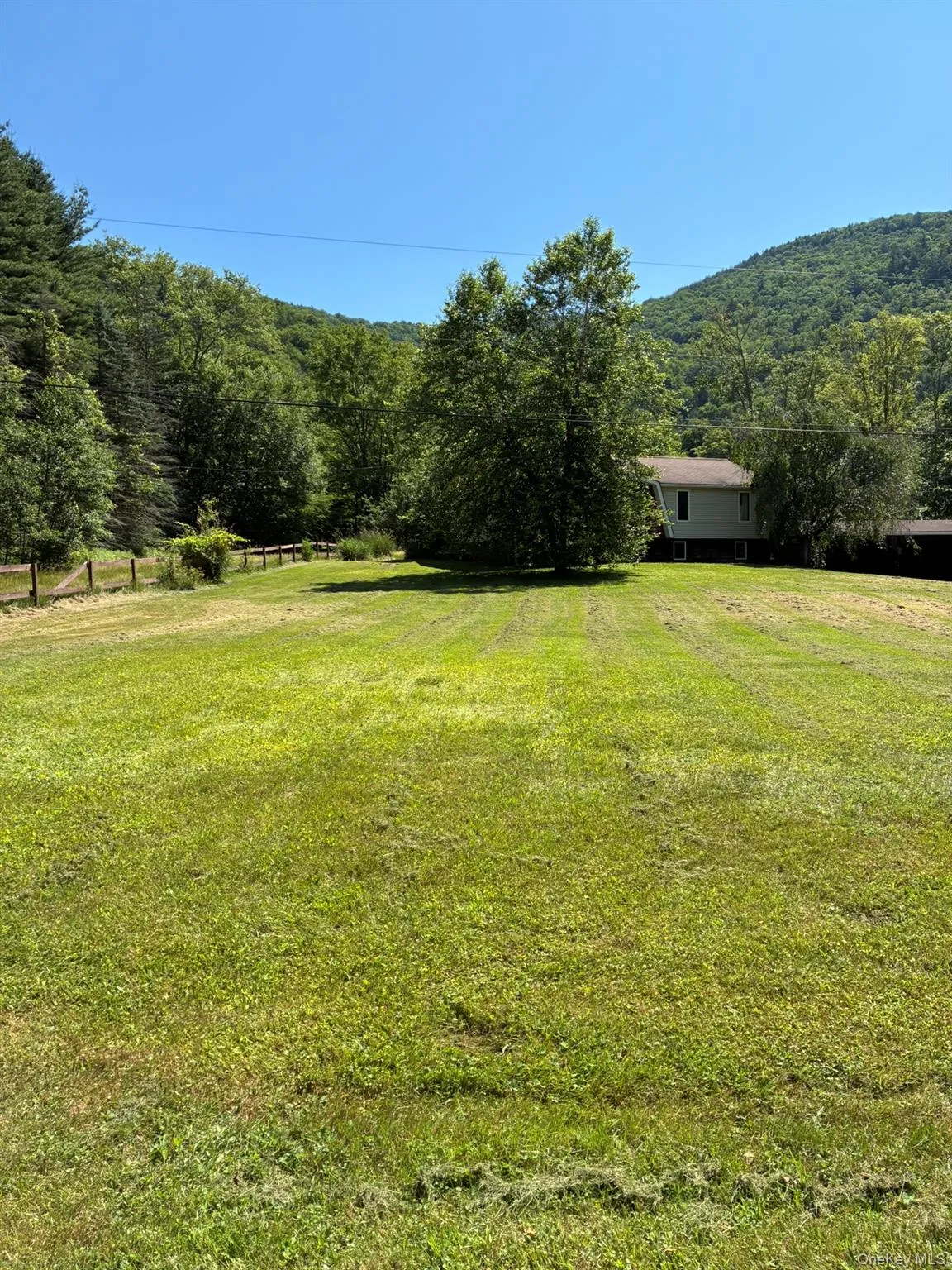 View of green lawn with a view of rural / pastoral area and a view of trees View of green lawn with a view of rural / pastoral area and a view of trees