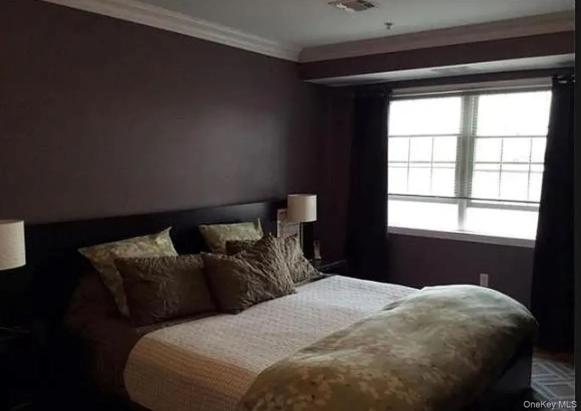 Bedroom featuring ornamental molding Bedroom featuring ornamental molding