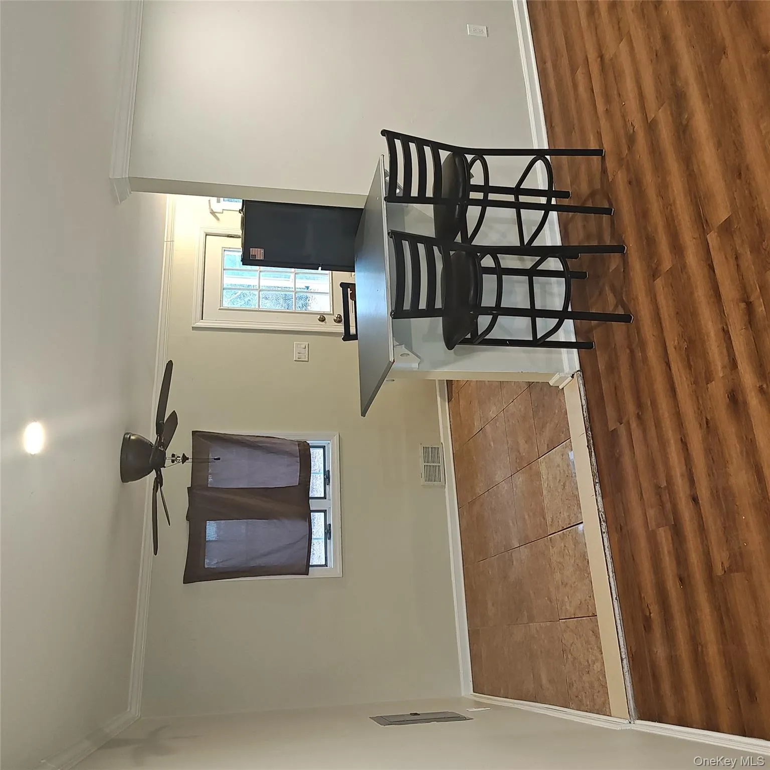 Dining area featuring ornamental molding, dark wood-type flooring, and ceiling fan Dining area featuring ornamental molding, dark wood-type flooring, and ceiling fan