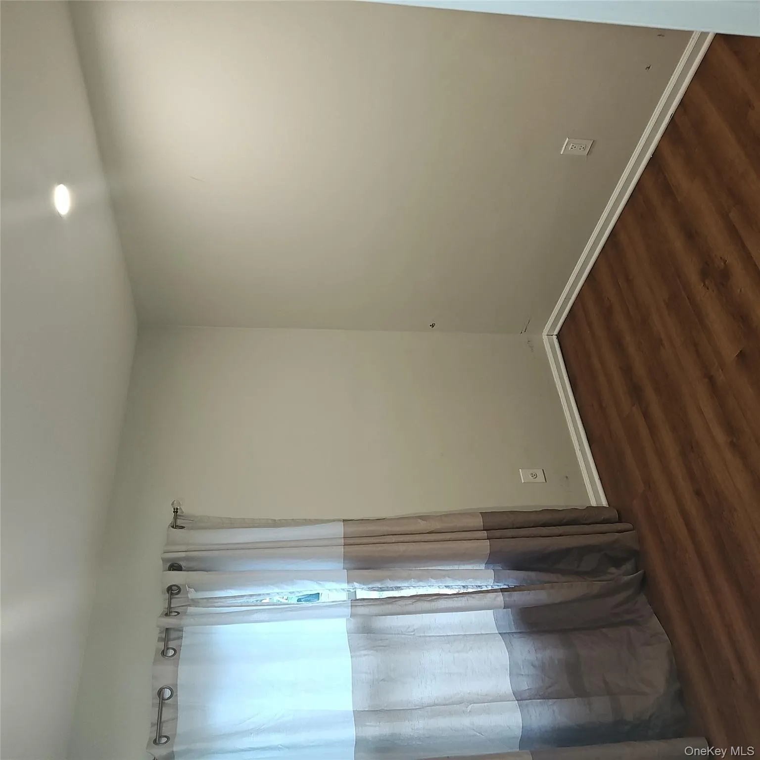 Empty room featuring dark wood-type flooring and baseboards Empty room featuring dark wood-type flooring and baseboards