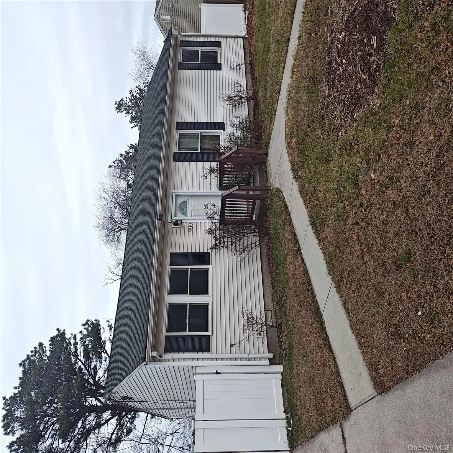 Single story home with roof with shingles and a gate Single story home with roof with shingles and a gate