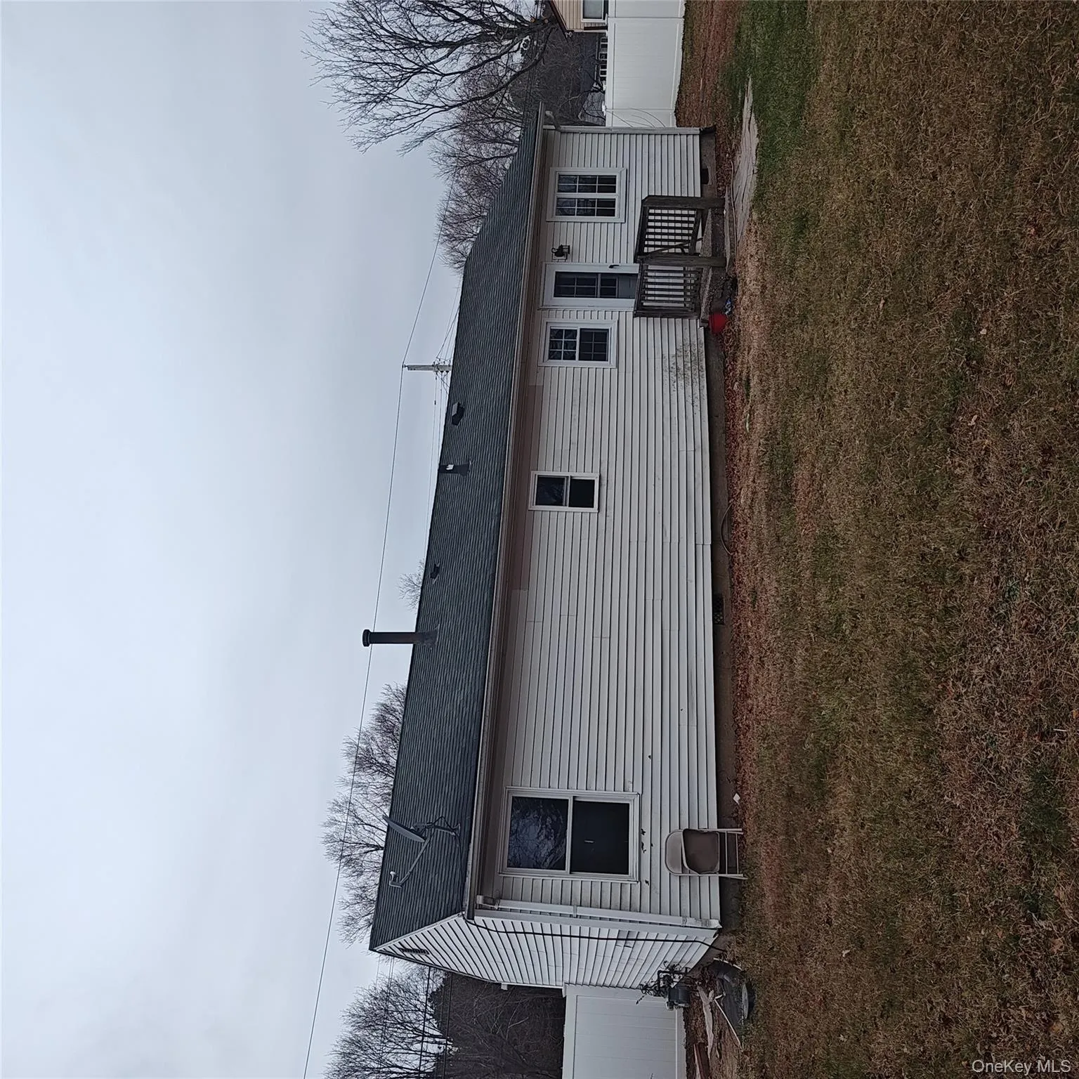 Back of property with roof with shingles and a deck Back of property with roof with shingles and a deck