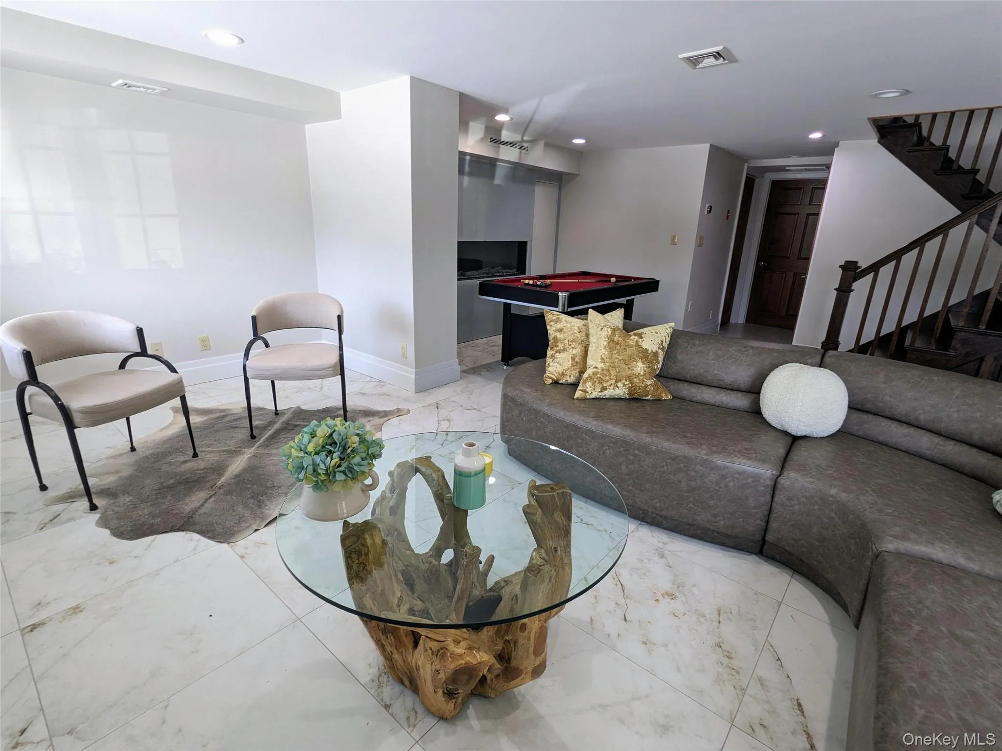 Family room with light marble, radiant heated floors, recessed lighting Family room with light marble, radiant heated floors, recessed lighting