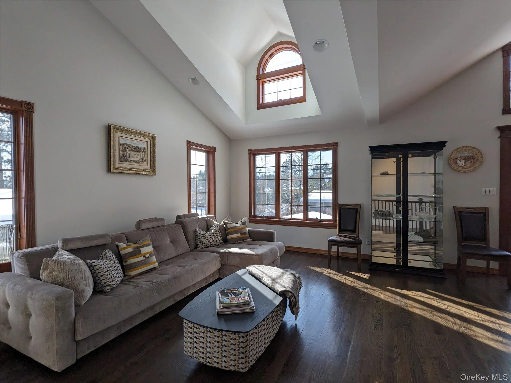 Living area with high vaulted ceiling and hardwood / wood-style floors Living area with high vaulted ceiling and hardwood / wood-style floors