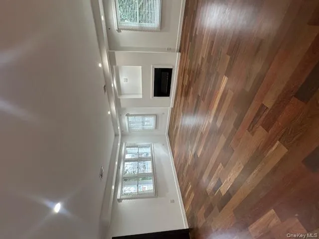 Unfurnished living room featuring a fireplace, dark wood-type flooring, and recessed lighting Unfurnished living room featuring a fireplace, dark wood-type flooring, and recessed lighting
