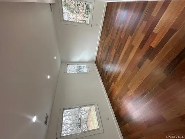 Unfurnished room with dark wood-style floors and recessed lighting Unfurnished room with dark wood-style floors and recessed lighting