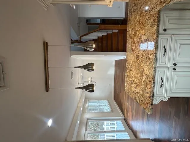 Kitchen featuring a peninsula, open floor plan, pendant lighting, light stone counters, and recessed lighting Kitchen featuring a peninsula, open floor plan, pendant lighting, light stone counters, and recessed lighting