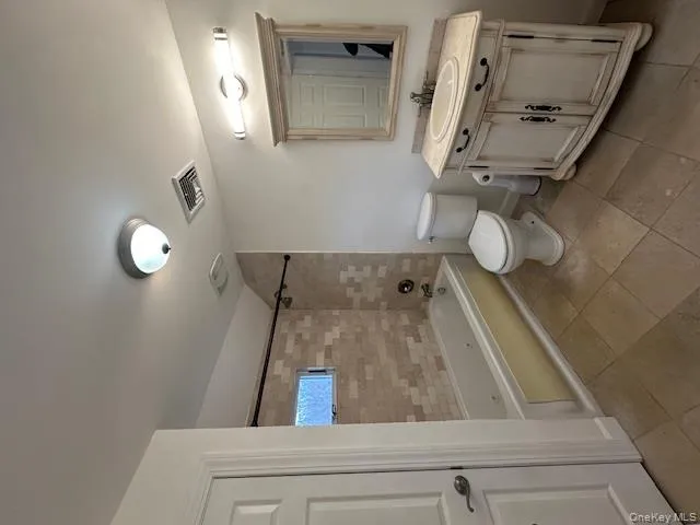 Bathroom featuring vanity, shower / washtub combination, and light tile patterned flooring Bathroom featuring vanity, shower / washtub combination, and light tile patterned flooring