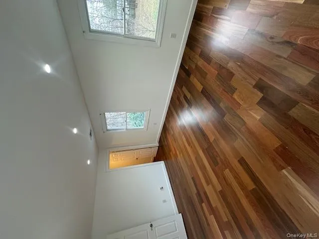 Unfurnished room featuring dark wood-style flooring and recessed lighting Unfurnished room featuring dark wood-style flooring and recessed lighting