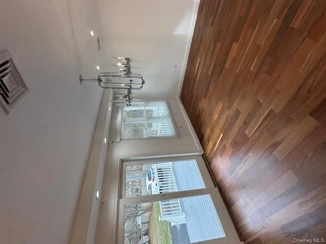 Unfurnished dining area featuring dark wood finished floors, a chandelier, and recessed lighting Unfurnished dining area featuring dark wood finished floors, a chandelier, and recessed lighting
