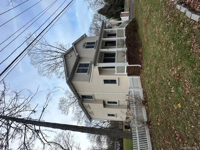 View of side of home featuring stucco siding and covered porch View of side of home featuring stucco siding and covered porch