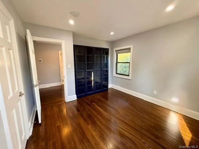 Unfurnished bedroom featuring dark wood-style flooring, recessed lighting, and a closet Unfurnished bedroom featuring dark wood-style flooring, recessed lighting, and a closet
