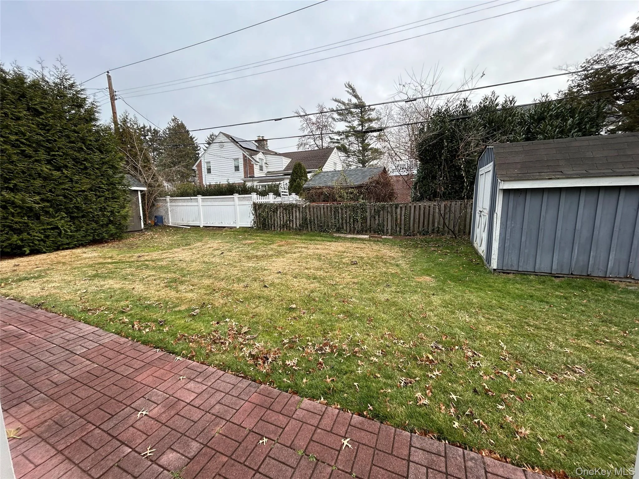 Fenced backyard featuring a storage shed Fenced backyard featuring a storage shed