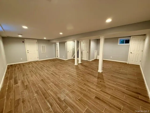 Finished basement with recessed lighting and wood finish floors Finished basement with recessed lighting and wood finish floors