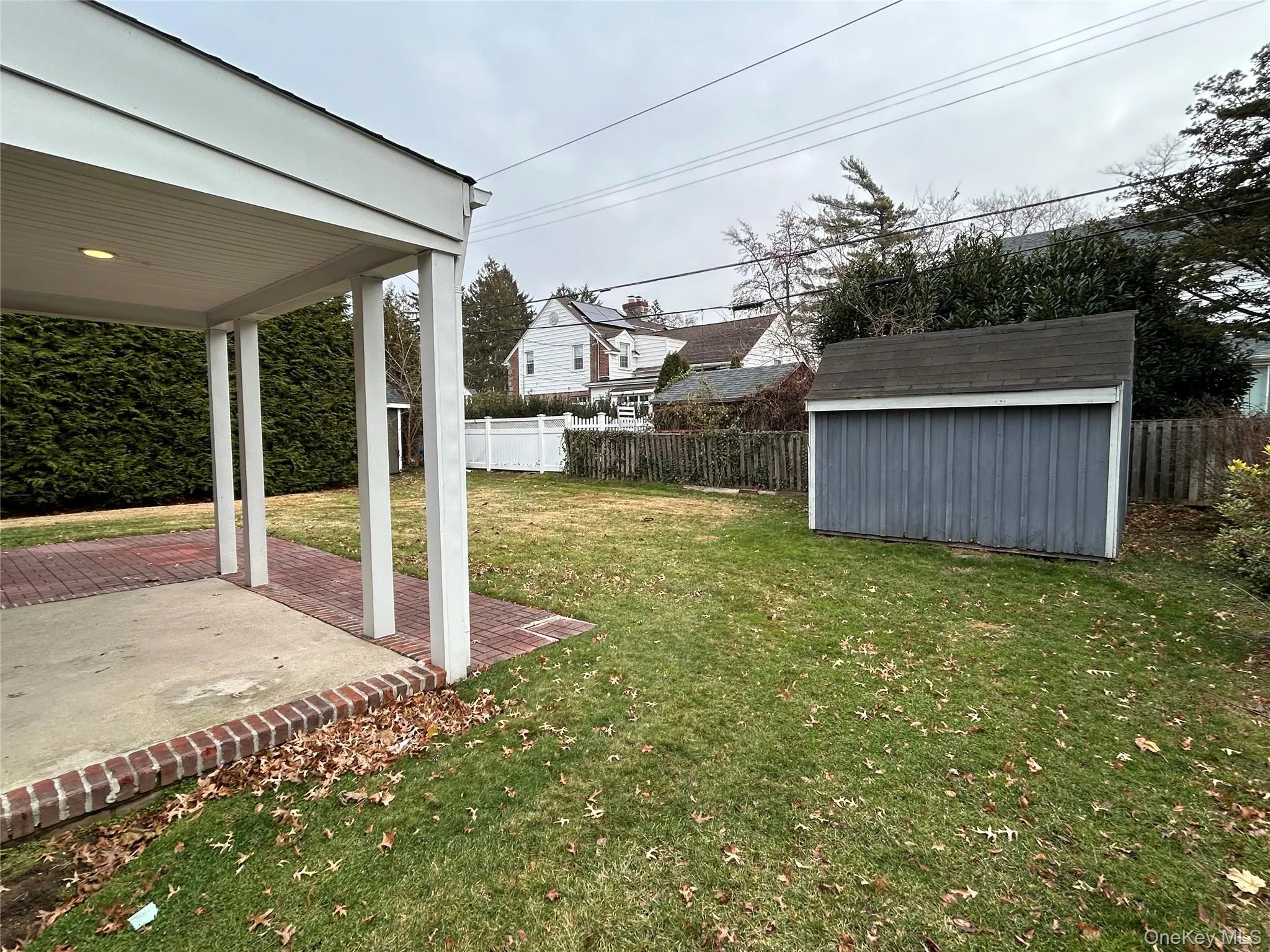 Fenced backyard featuring a shed and a patio area Fenced backyard featuring a shed and a patio area
