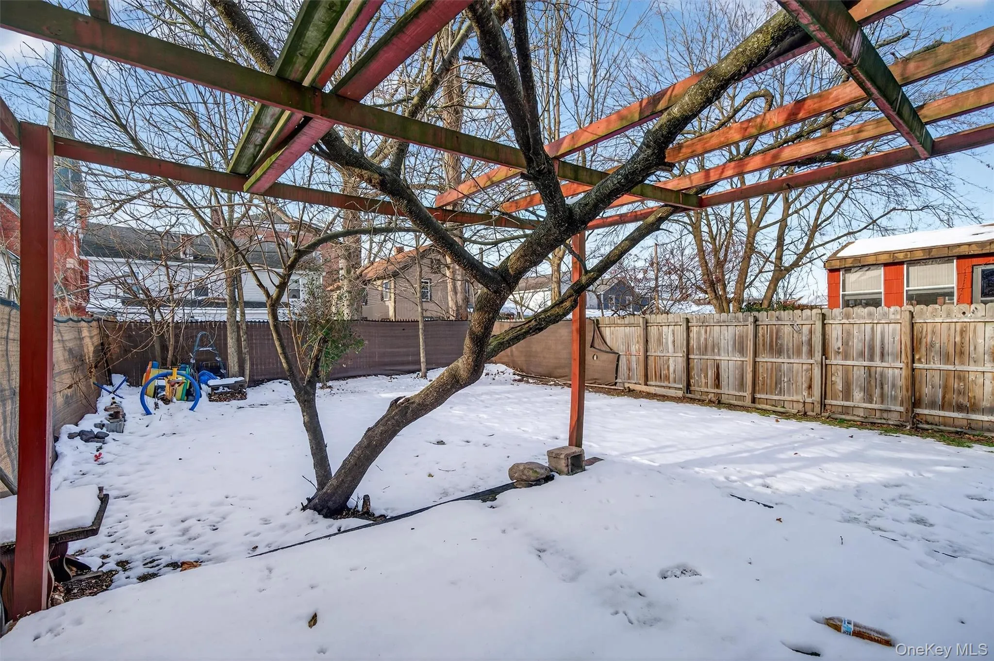Yard covered in snow featuring a fenced backyard Yard covered in snow featuring a fenced backyard