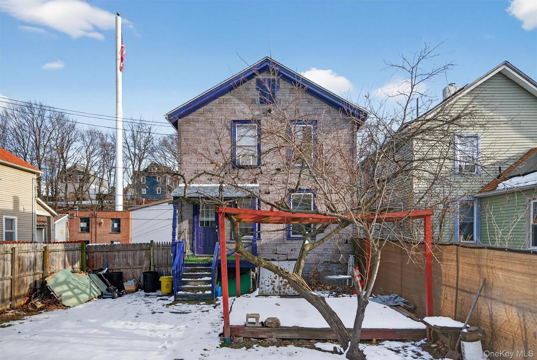 Snow covered rear of property with a fenced backyard Snow covered rear of property with a fenced backyard