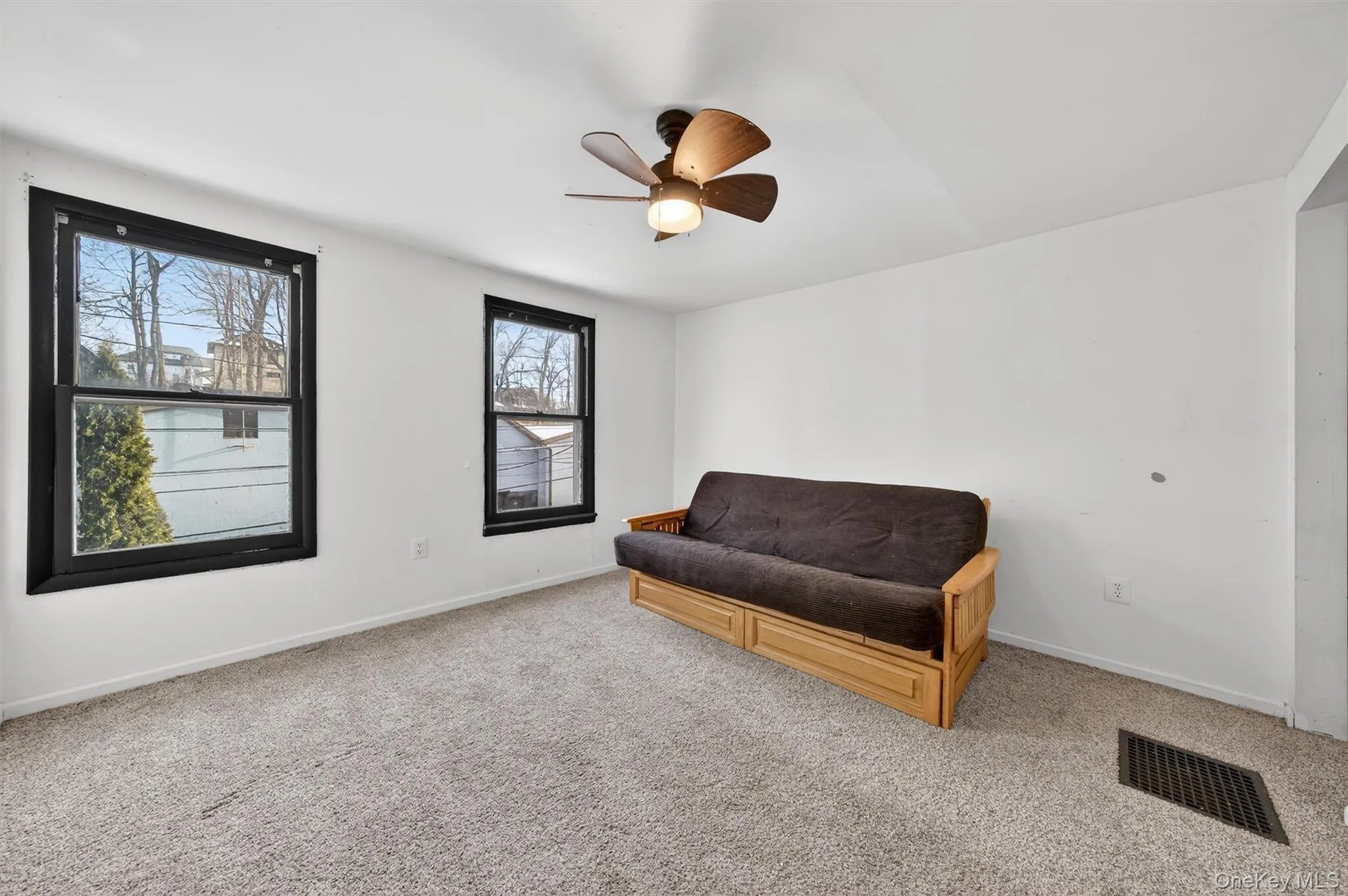 Sitting room with carpet flooring and ceiling fan Sitting room with carpet flooring and ceiling fan