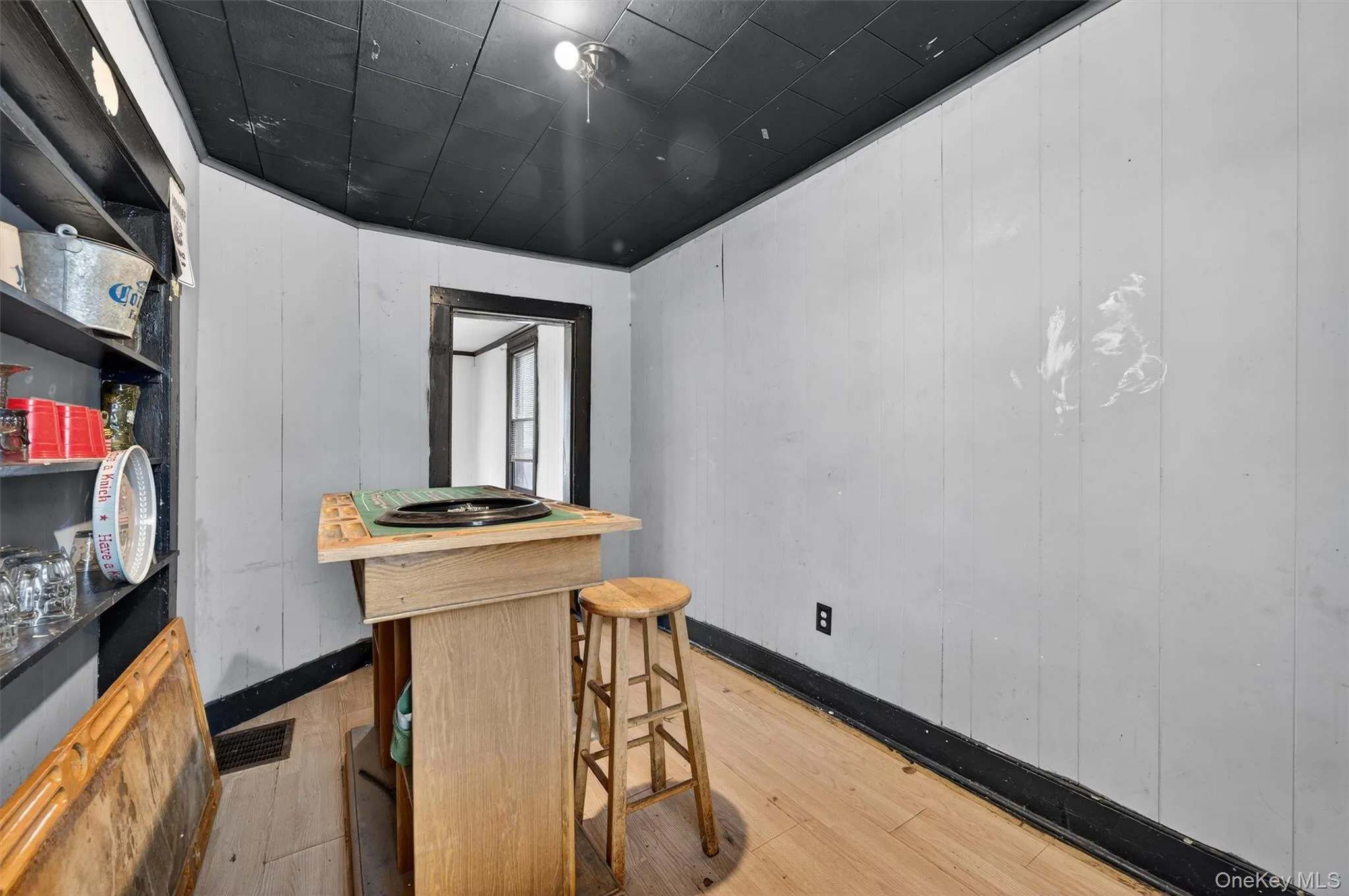 Bar area with hardwood / wood-style floors and wood walls Bar area with hardwood / wood-style floors and wood walls