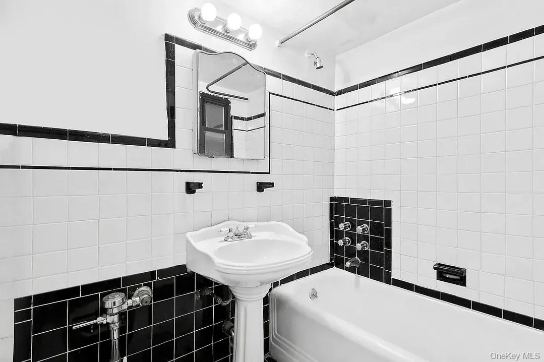 Bathroom with tile walls and shower / washtub combination Bathroom with tile walls and shower / washtub combination