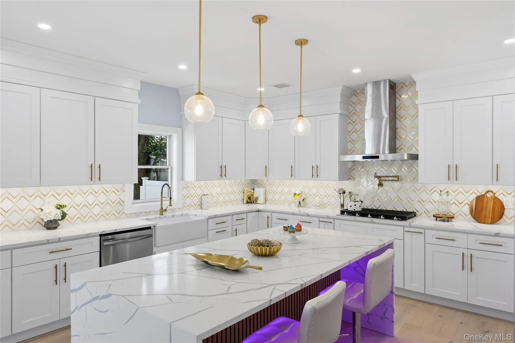 Kitchen featuring light stone countertops, white cabinets, decorative light fixtures, light wood-type flooring, and recessed lighting Kitchen featuring light stone countertops, white cabinets, decorative light fixtures, light wood-type flooring, and recessed lighting