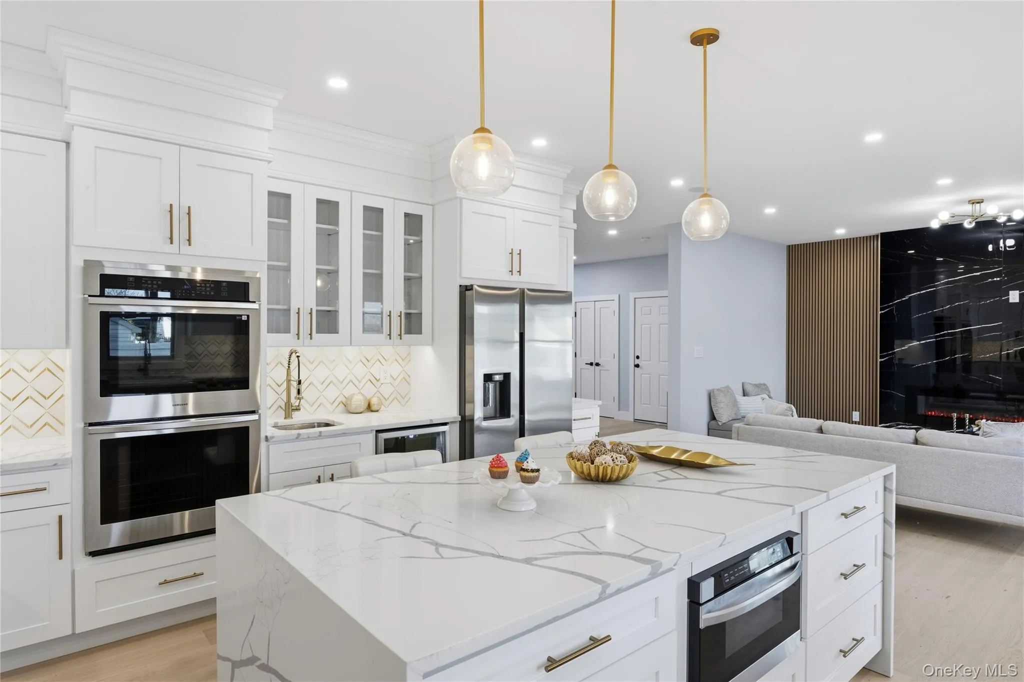 Kitchen featuring open floor plan, appliances with stainless steel finishes, light stone counters, white cabinetry, and recessed lighting Kitchen featuring open floor plan, appliances with stainless steel finishes, light stone counters, white cabinetry, and recessed lighting