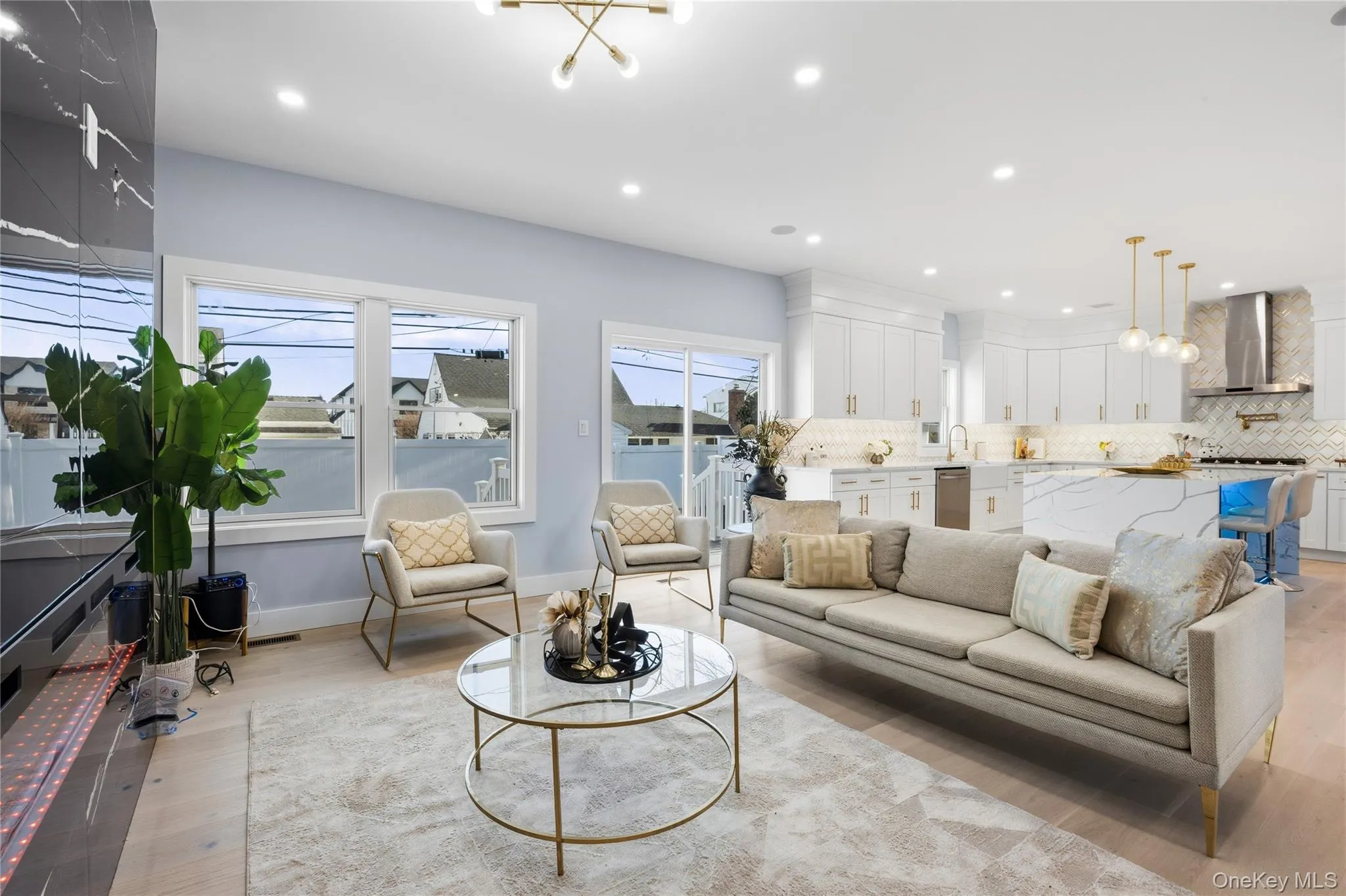Living area featuring light wood-style flooring, recessed lighting, and a chandelier Living area featuring light wood-style flooring, recessed lighting, and a chandelier
