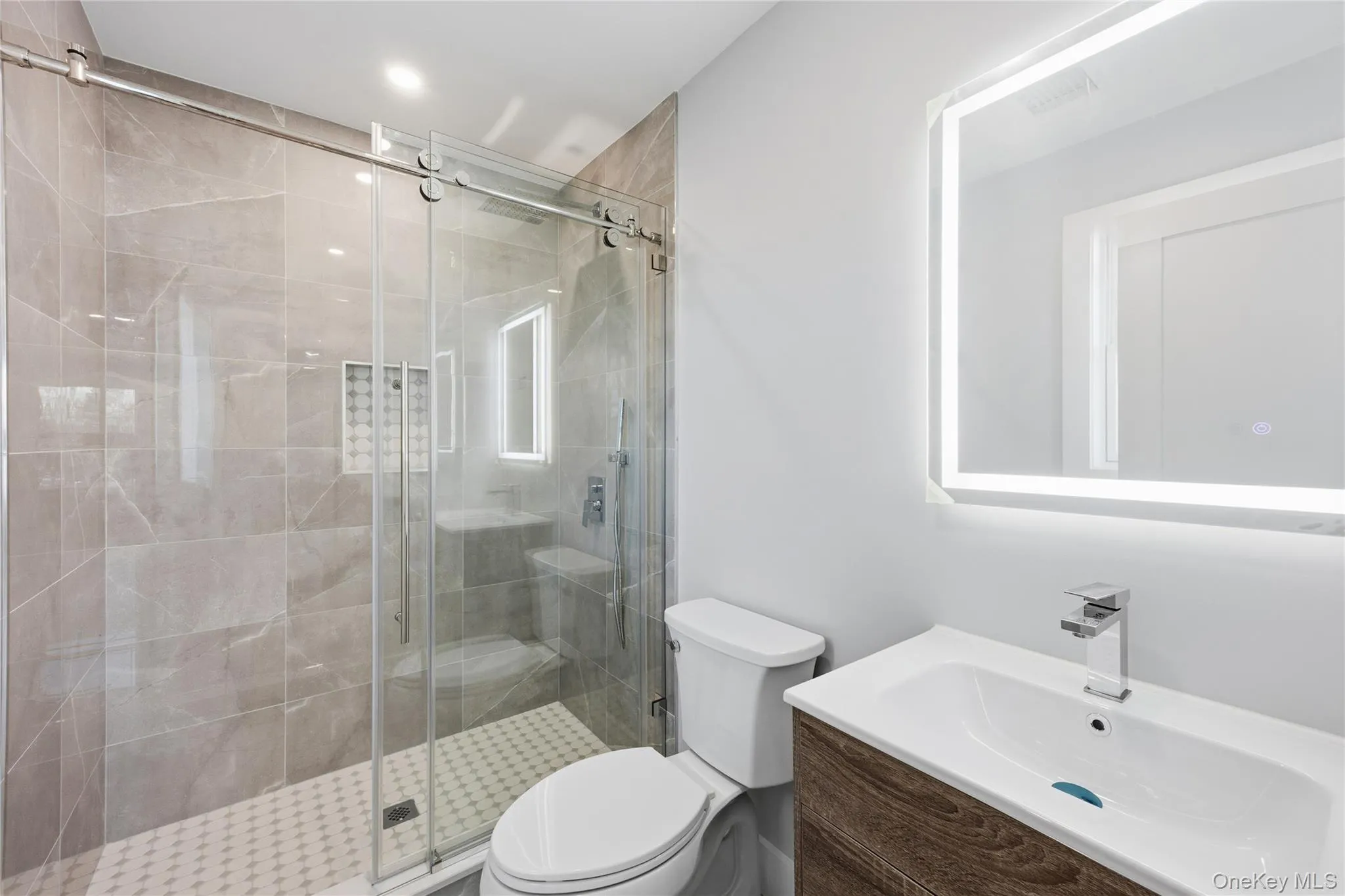 Full bathroom featuring a stall shower and vanity Full bathroom featuring a stall shower and vanity
