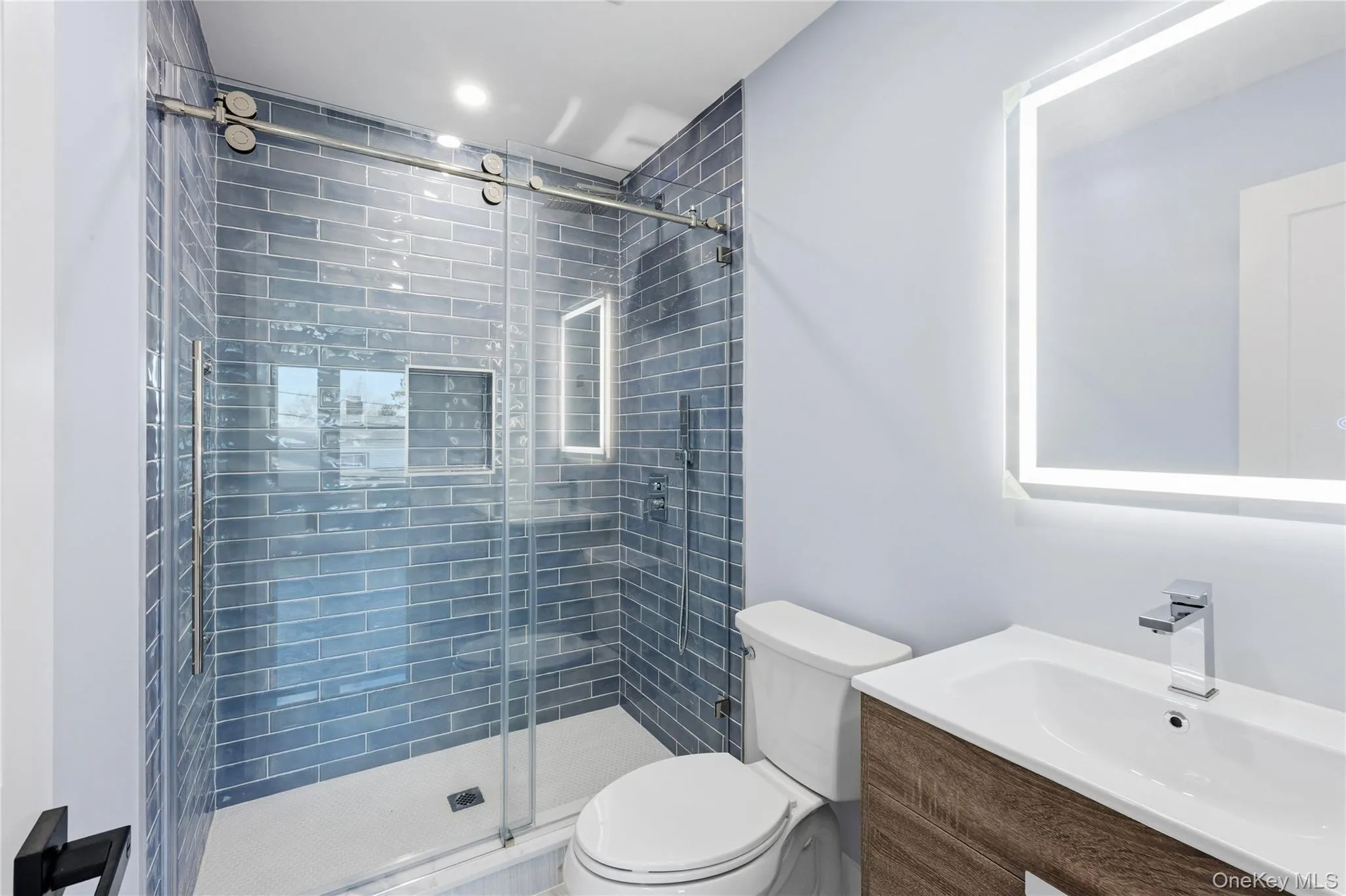 Full bath with vanity and a shower stall Full bath with vanity and a shower stall